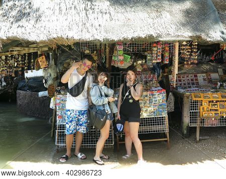 Asian Tourists On The Beach At The Famous Khao Ping Kan, Also Known As James Bond Island In Phang Ng
