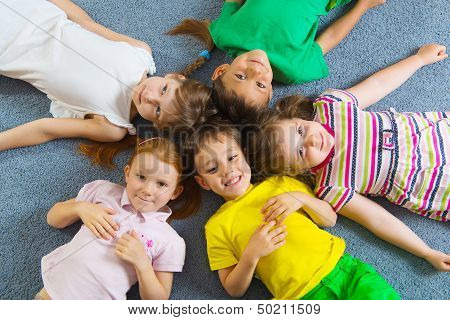 Cute Little Children Lying On Floor