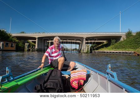 Elderly man in boat at the river