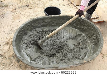 Mixing A Cement In Salver For Applying Construction