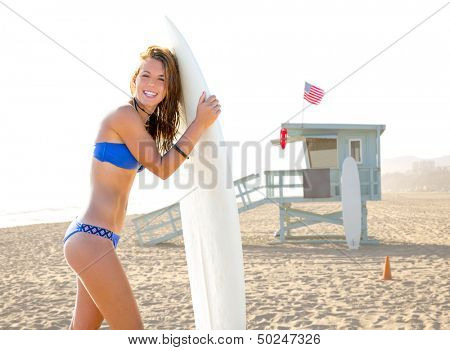 Beautiful surfer teen girl with surfboard in Santa Monica beach California Lifeguard house [ photo-illustration]