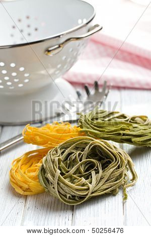 Italian pasta tagliatelle on wooden table