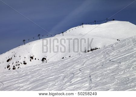 Off-piste Slope And Ropeway Against Blue Sky