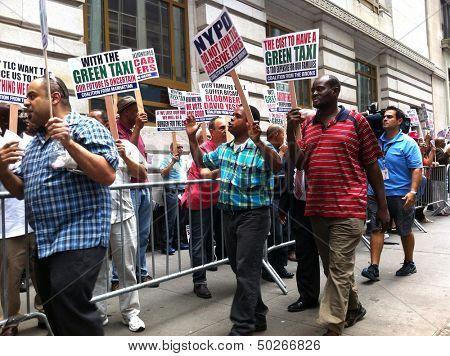 NEW YORK - SEPTEMBER 3: Taxi drivers protest outside the Taxi and Limousine Commission building in protest of new rules on September 3, 2013 in New York City.