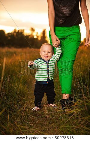 Adorable Baby Walking Around With Mother