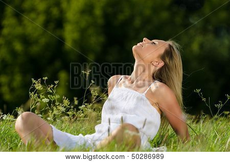 young woman practicing yoga in nature