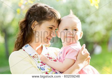 Loving Mother With Baby Girl Outdoors