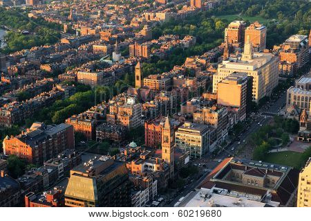 Boston city downtown aerial view with urban historical buildings at sunset.