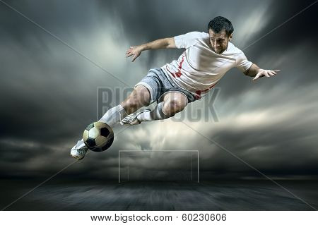 Football player with ball on field of stadium