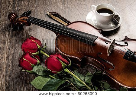 Violin, rose, coffee and music books