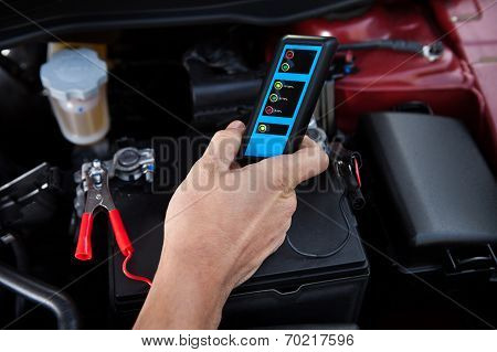 Mechanic Testing Car Battery