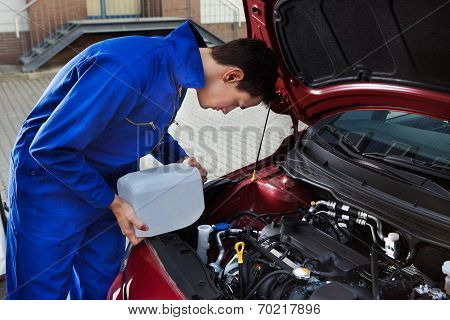 Mechanic Pouring Antifreeze Into Windscreen Water Tank