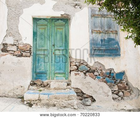 Old Wooden Door Of A Shabby Demaged House Facade Or Front.
