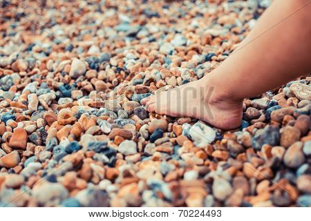 The Foot Of A Young Woman On The Beach