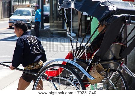 Tourists take a rickshaw in japan