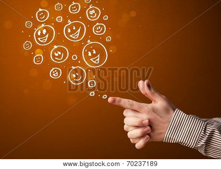 Group of happy hand drawed smiley faces coming out of gun shaped hands