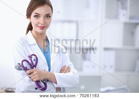 Portrait of happy successful young female doctor holding a stet