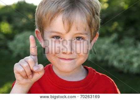 Smiling boy with a bandaged finger