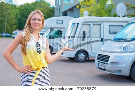 Beautiful Young Woman Offers Campervans At Shop.