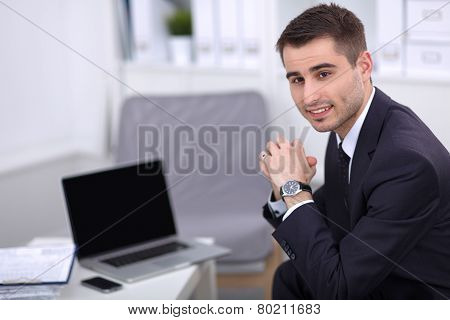 young businessman sitting in his office