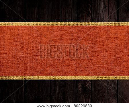 mordant red jute canvas banner textured with dark wood background