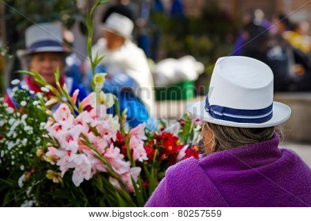 Indigenous woman selling flowers in Plaza de Flores Cuenca Ecuador