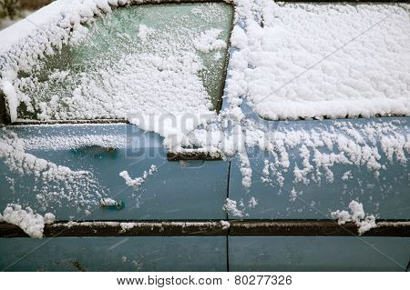 Snow Fals On Door Of Blue Car