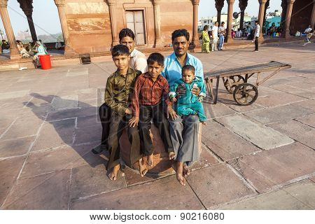 Father With His Children Rests On Courtyard Of Jama Masjid Mosque In Delhi