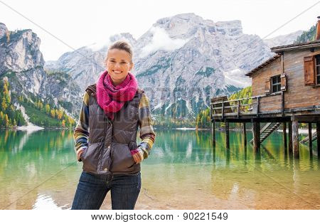 Woman Standing Smiling At Lake Bries In The Italian Dolomites
