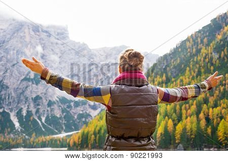Woman Hiker Opening Arms In Joy Against Autumn Background
