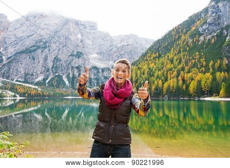 A Happy, Smiling Woman Hiker Giving Lake Bries Two Thumbs Up