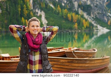 Woman Hiker With Hands Behind Her Head Relaxes On Lake Bries