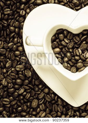 Cup And Saucer On Coffee Beans Background