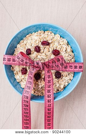 Oatmeal In Blue Bowl With Measuring Tape Around