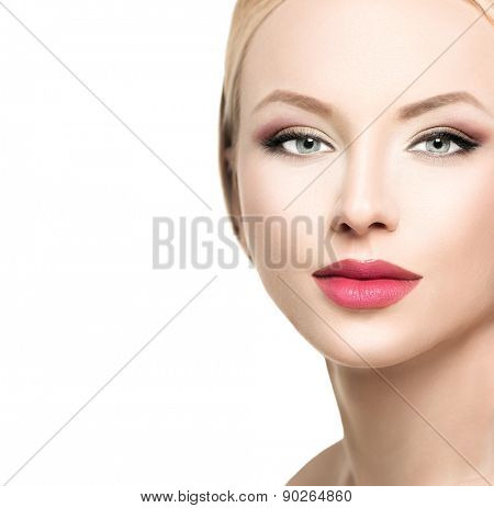Beautiful blonde woman face close up. Portrait of fashion model with clean skin, bright makeup. Isolated on white background. Beauty female. Skincare. Perfect make up