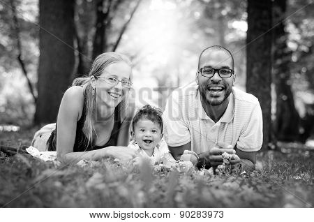 Happy Interracial Family Is Enjoying A Day In The Park. Little Mulatto Baby Boy. Black And White B&w