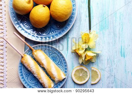 Lemons and ice cream on plates on table top view