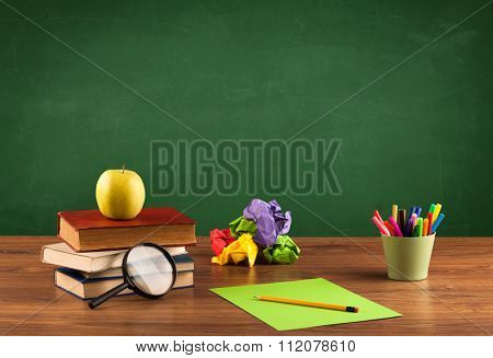 Back to school concepty with clear blackboard background, desk, items