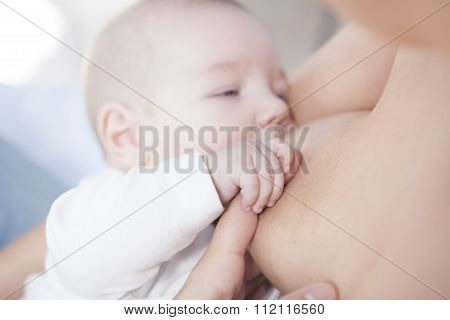 Baby Holds Her Mom Hand While He Is Breastfed