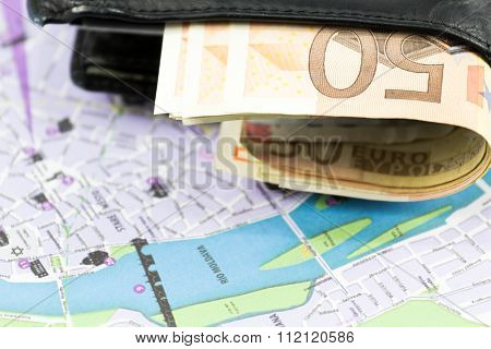 European union currency in a wallet and map
