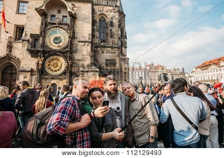 Group of tourists taking pictures against background of sights -