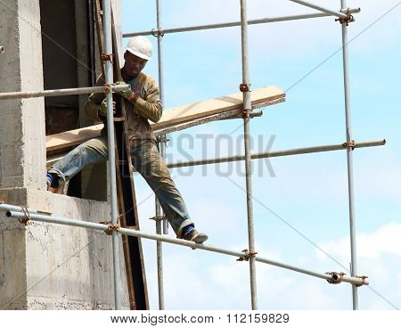 CUREPIPE, MAURITIUS ISLAND - 28. OCTOBER, 2015: Unidentified African worker on a scaffold build new touristic resort on the Mauritius coast.
