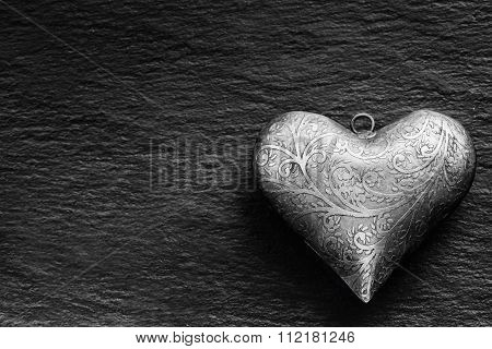 Valentine Metal heart on a granite board. Valentine's two silver heart with ornament