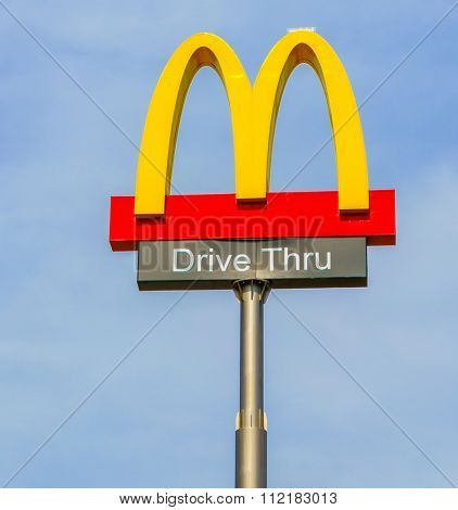 Khonkaen Province, Thailand - December 20, 2015 : McDonalds logo on blue sky McDonald's Corporation is the world's largest chain of hamburger fast food restaurants.