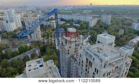 MOSCOW - SEP 15, 2015: Crane above building site of residential complex Falcon Fort at autumn evening. Aerial view videoframe