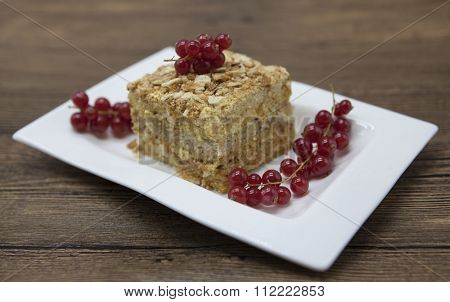 Fresh delicious diet cake with berry red currant at Dukan Diet on a porcelain plate with a spoon on a wooden background