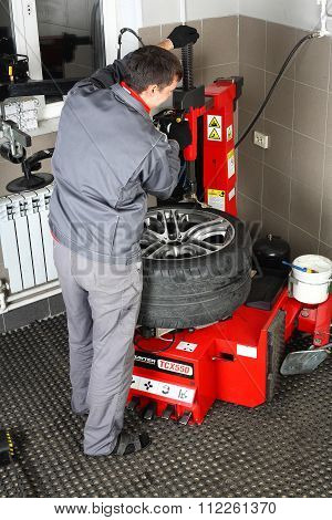 Car Service. The Worker Repair Of Tires Wheel