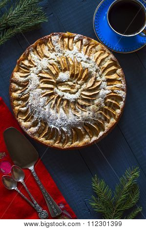 Apple pie, cup of coffee on deep blue background