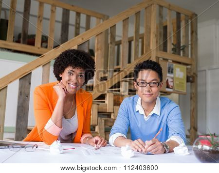 Two desingers working on a project together in office