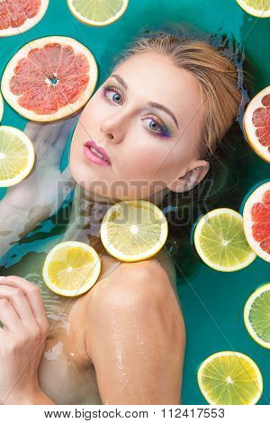 Beautiful woman with shiny skin in blue water